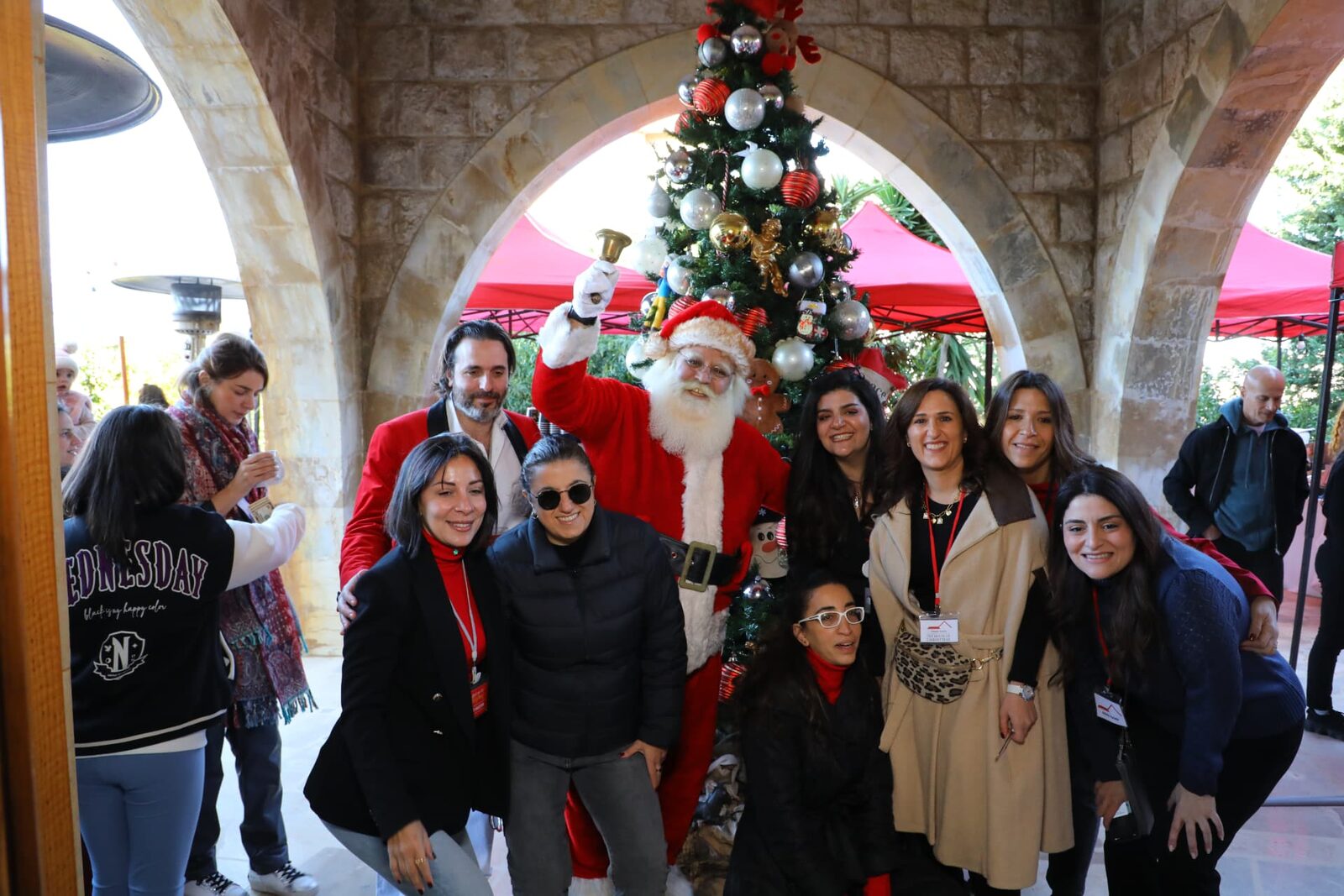 Santa with visitors under the stone arches at the Christmas market