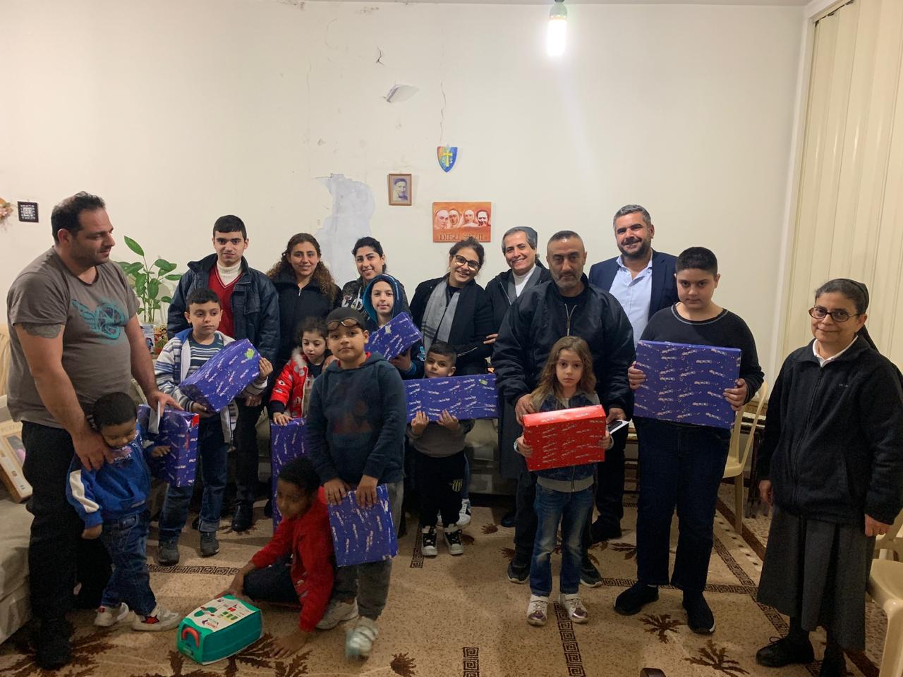 Families and children receiving Christmas gifts from House of Christmas volunteers