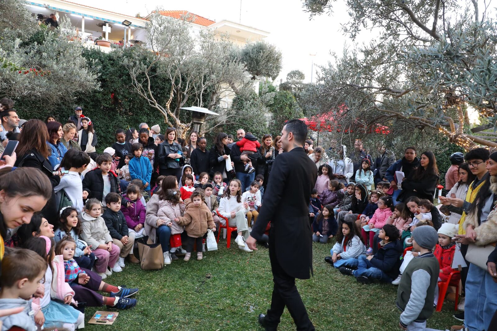 Children gathered in the garden for a performance